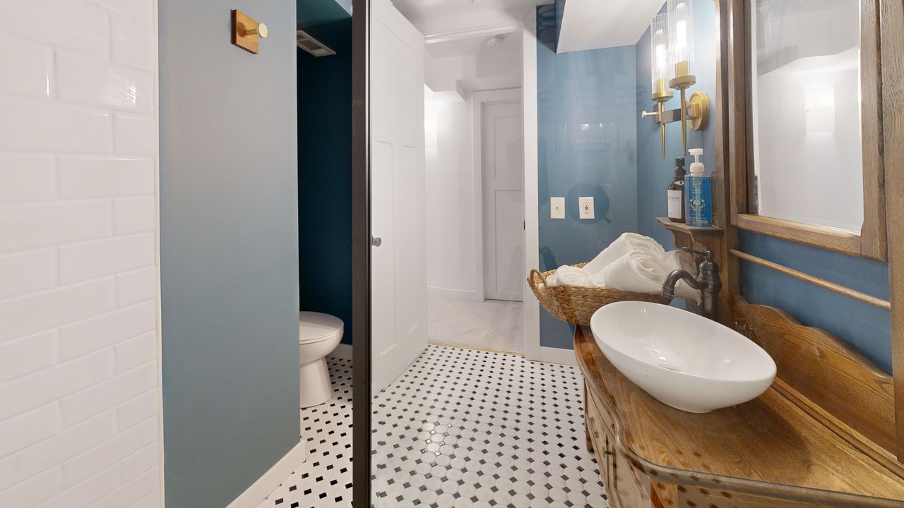 Bright, modern bathroom interior featuring rustic wood vanity and elegant vessel sink.